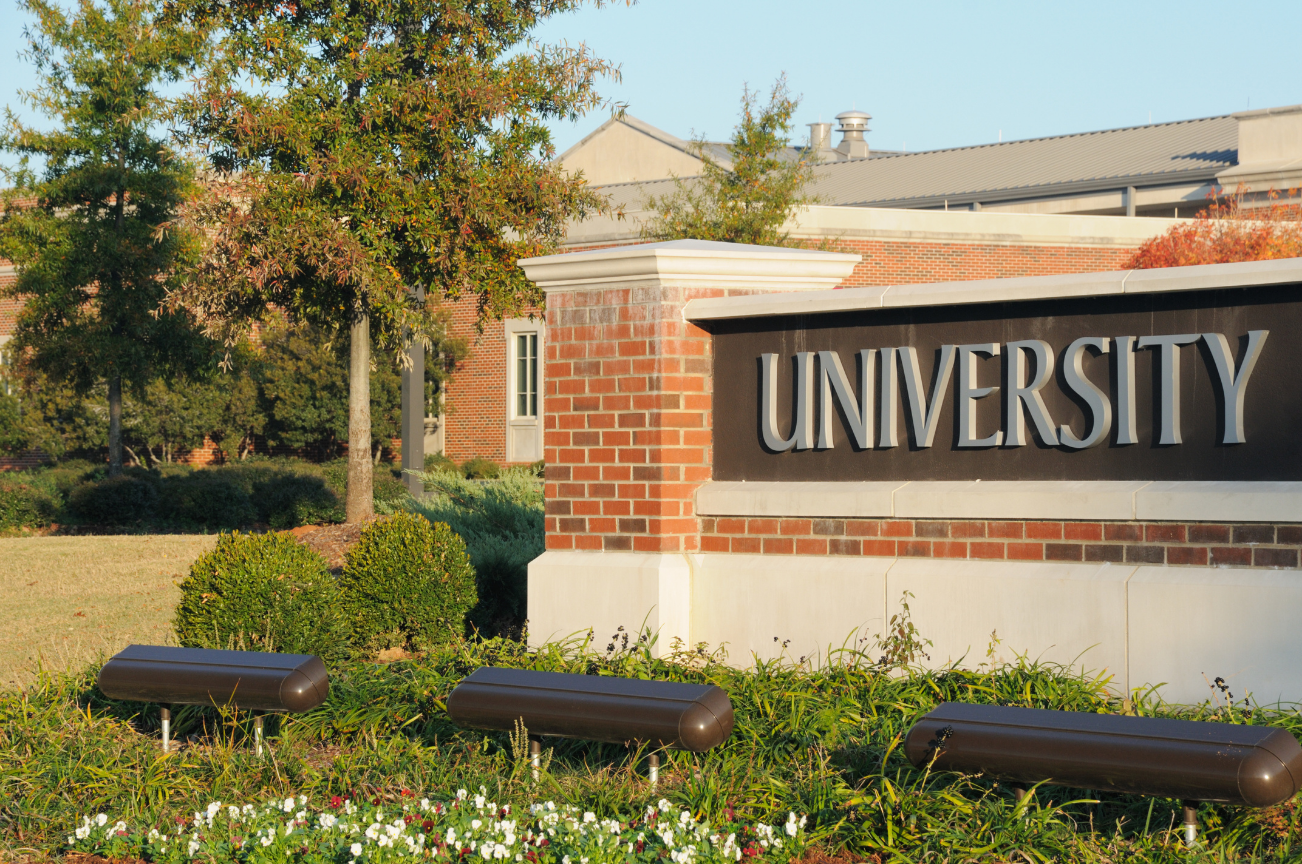 University campus entrance sign, symbolizing academic collaboration and vision science research partnerships